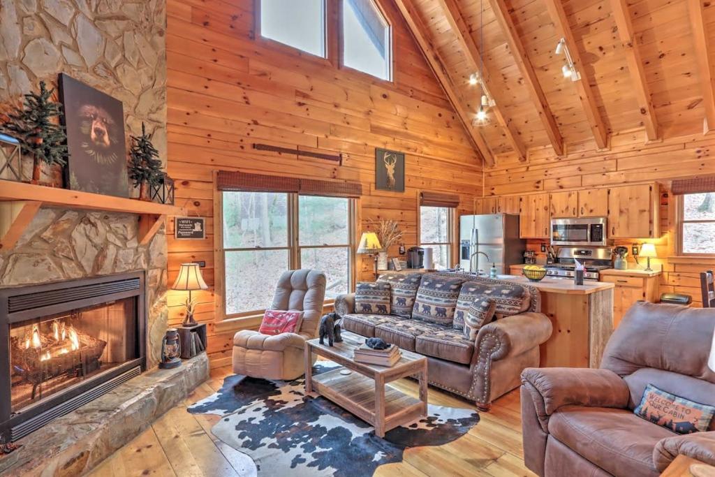 a living room with a fireplace in a log cabin at Pet-Friendly Mountain Retreat Fire Pit Hot Tub in Blue Ridge