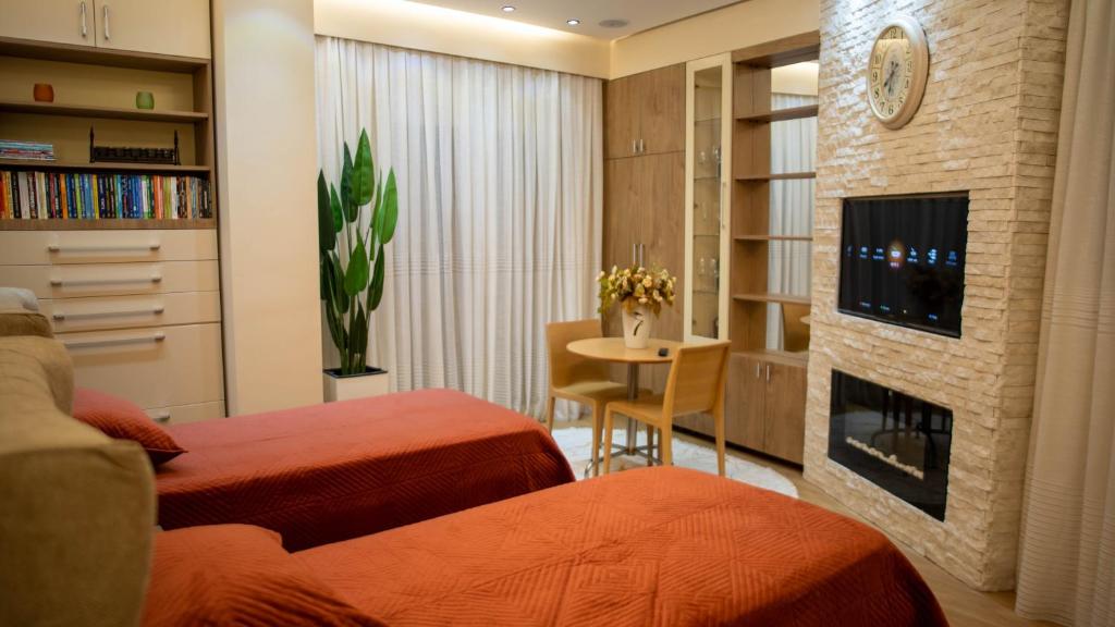 pokój hotelowy z 2 łóżkami i kominkiem w obiekcie Central Luxe Apartment w Tiranie