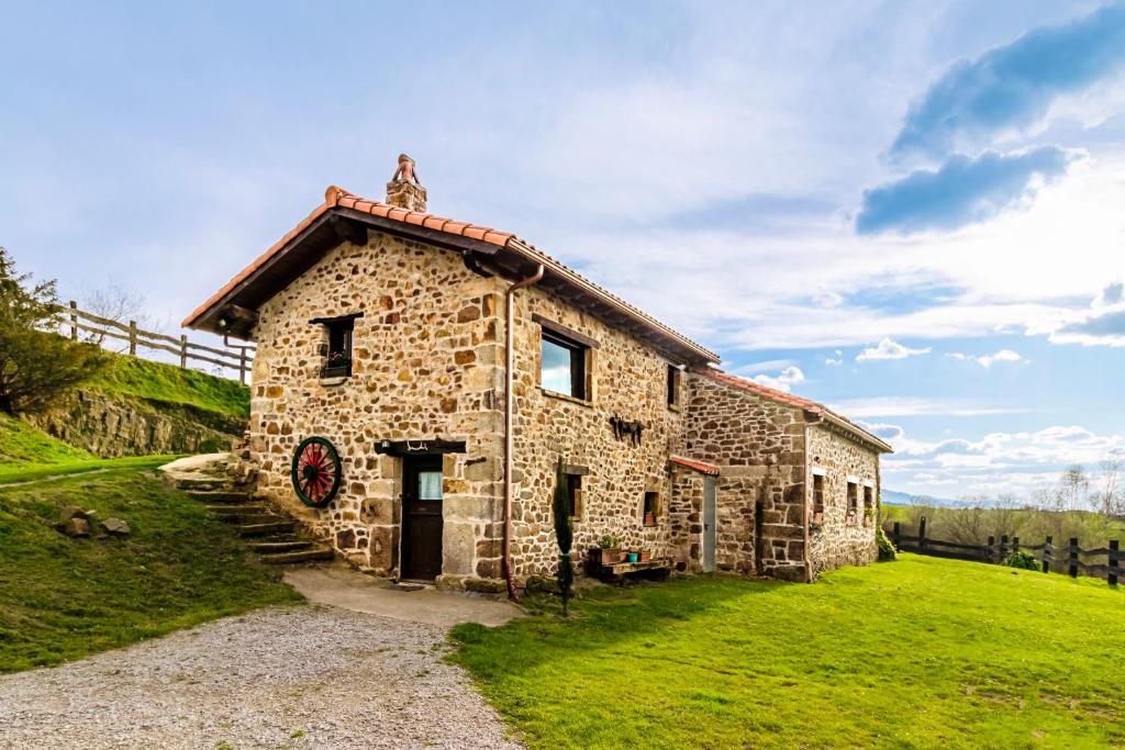 a stone building with a statue on top of it at Casa rural La alemana in Liérganes