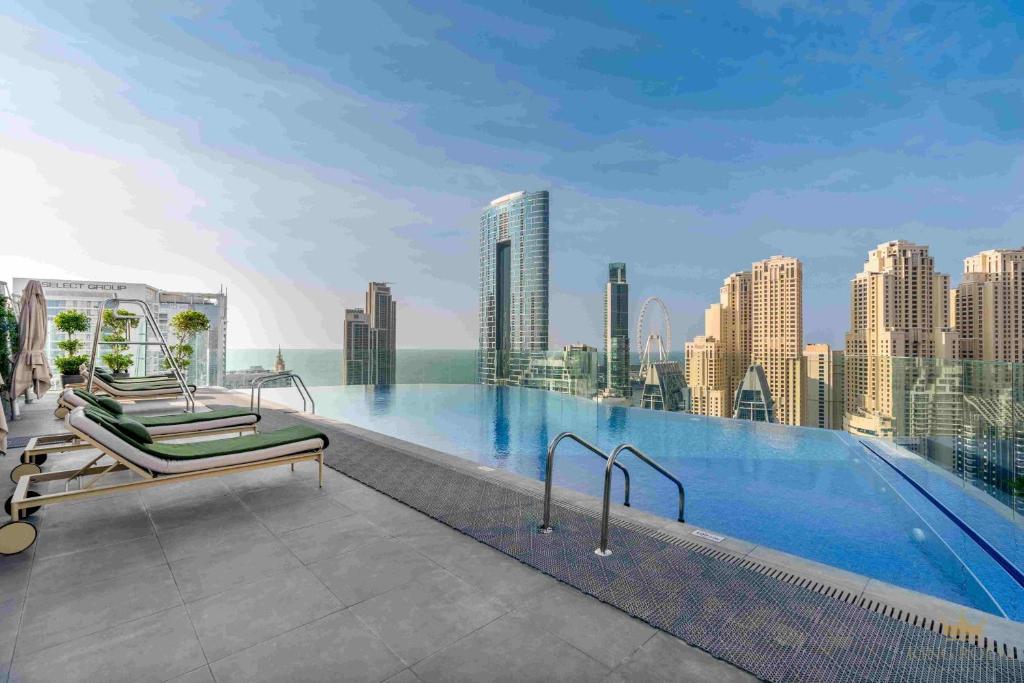 a swimming pool on the roof of a building at Stylish , apartments with esteemed facilities in Dubai Marina CMS in Dubai