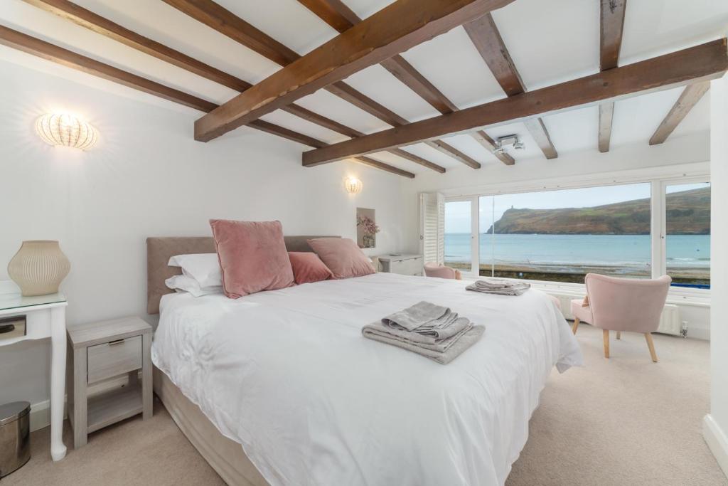 a bedroom with a bed and a view of the ocean at Seaview on the beach in Port Erin