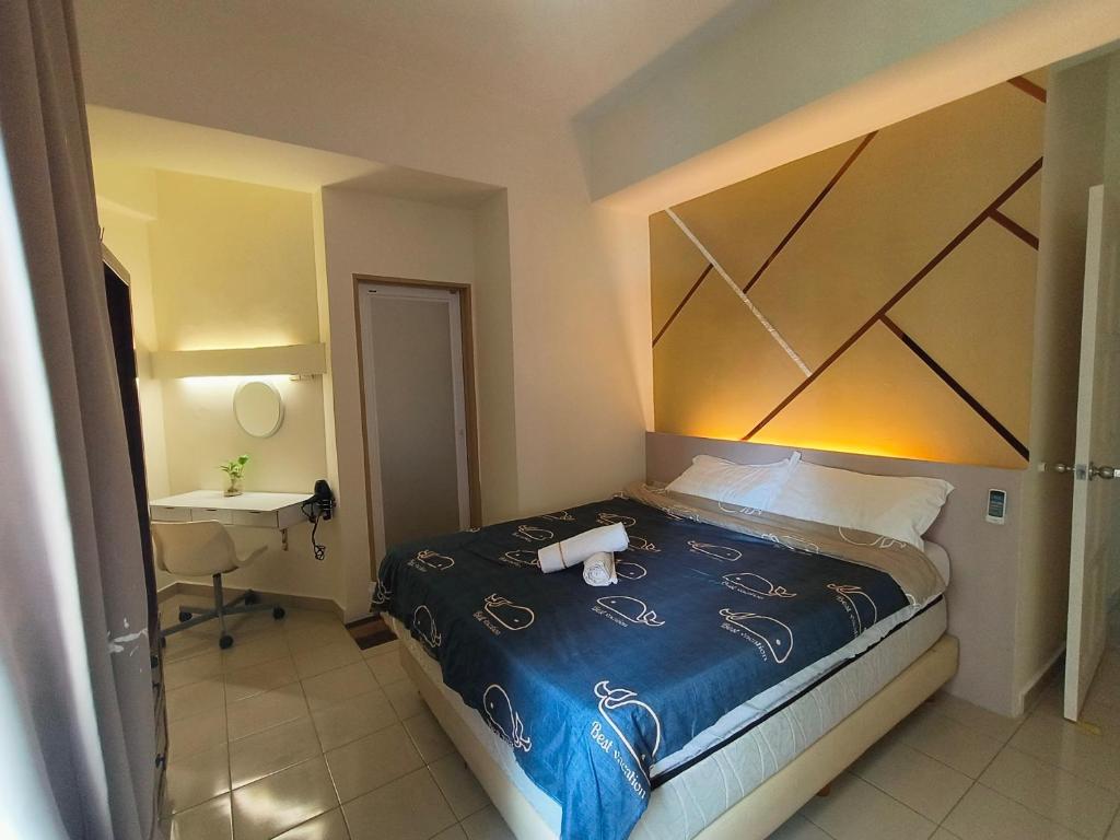 a bedroom with a large bed and a sink at VILLA PUTRA CONDOMINIUM in Kuala Lumpur