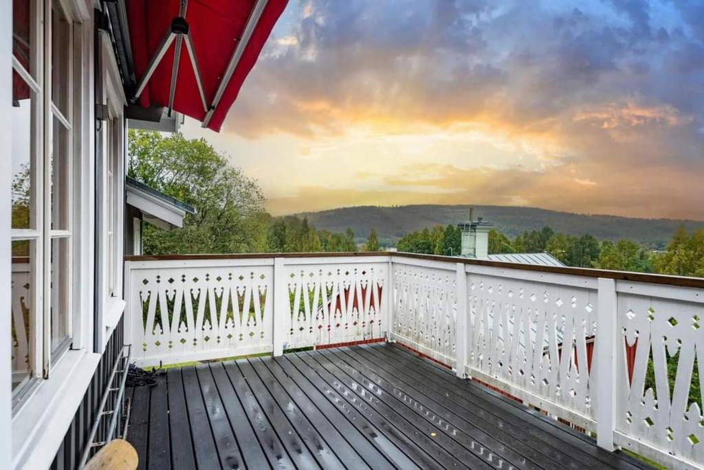 a balcony of a house with a white railing at Timrå Farmhouse in Timrå