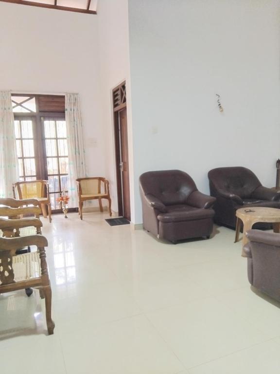 a living room with couches and chairs at Weligama Villa South in Weligama