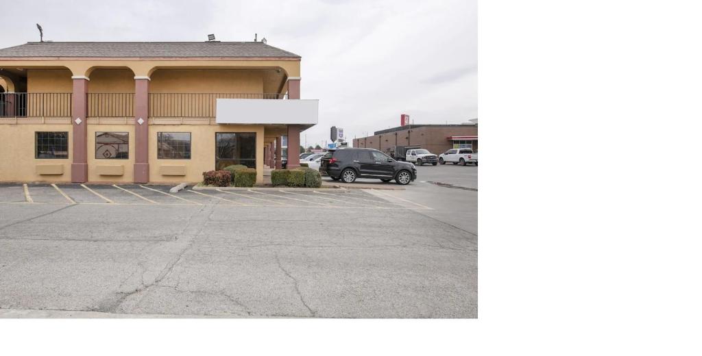 a parking lot in front of a building at Southern Comfort Hotel in Tulsa