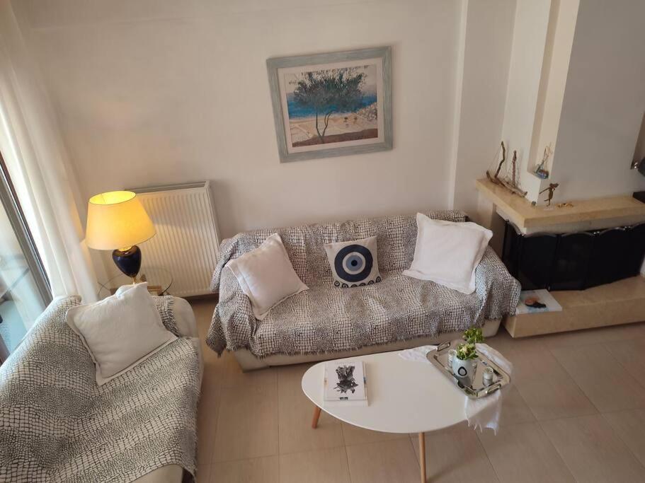 a living room with a couch and a table at Sophie's Cozy House in Patra