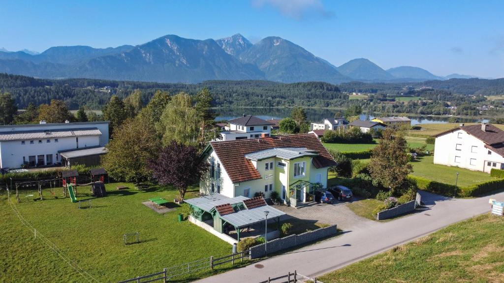 an aerial view of a house with mountains in the background at Ferienwohnungen Starmuz in Obersammelsdorf