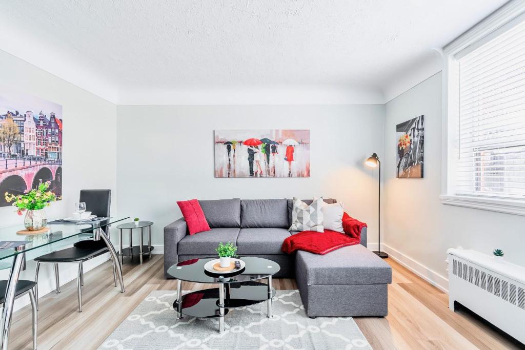a living room with a couch and a table at Corktown Hamilton - Modern Apartment in Hamilton