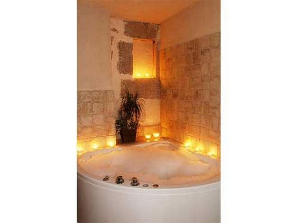 a bathroom with a tub with lights in it at House Marin in Starigrad