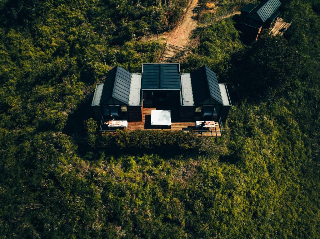 an aerial view of a house in a forest at The Boato Hotel in Guatapé