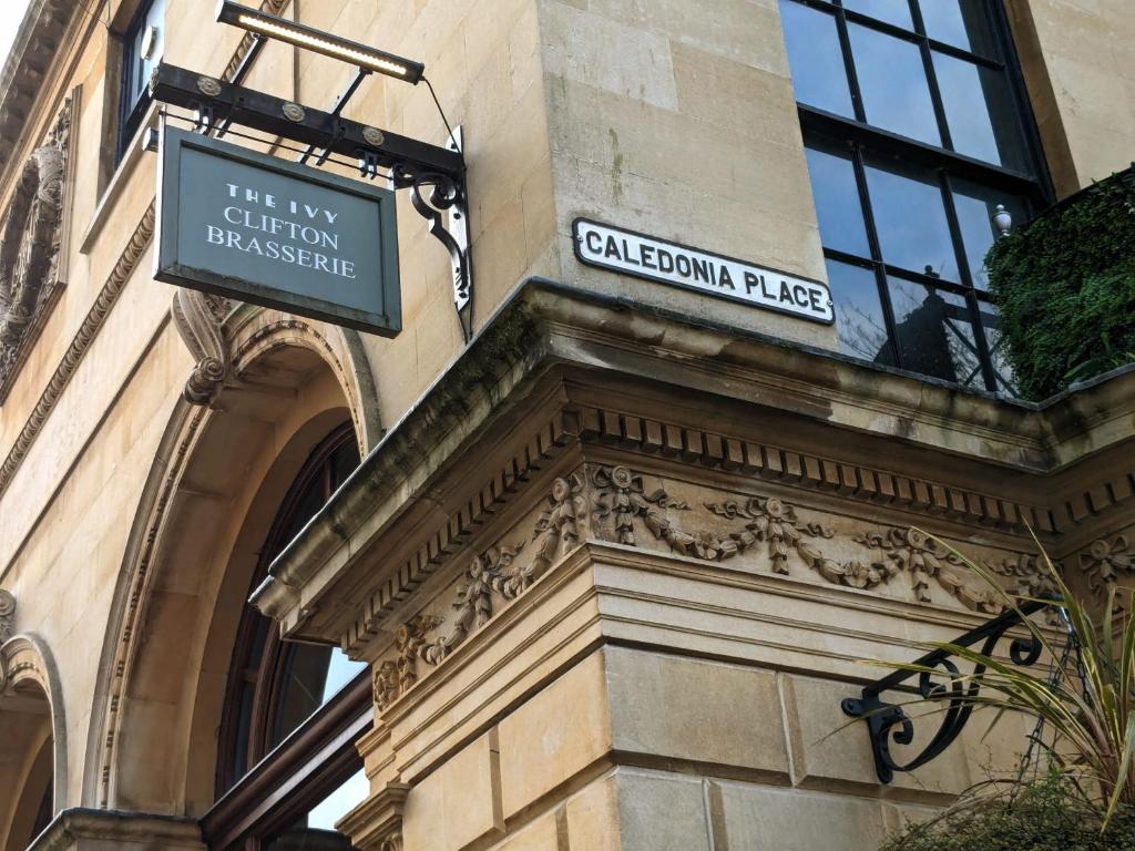 a sign on the side of a building at Two Bedroom flat in Caledonia Place in Bristol
