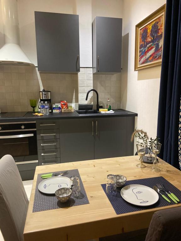 a kitchen with a wooden table with plates on it at Le Jean Jaurès in Troyes