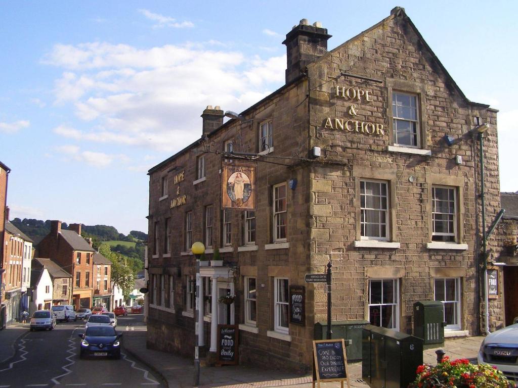 an old stone building on the corner of a street at Hope and Anchor in Wirksworth