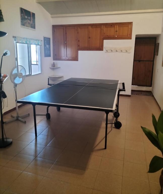 a ping pong table in the middle of a room at Casa Las Lomas in Prado del Rey