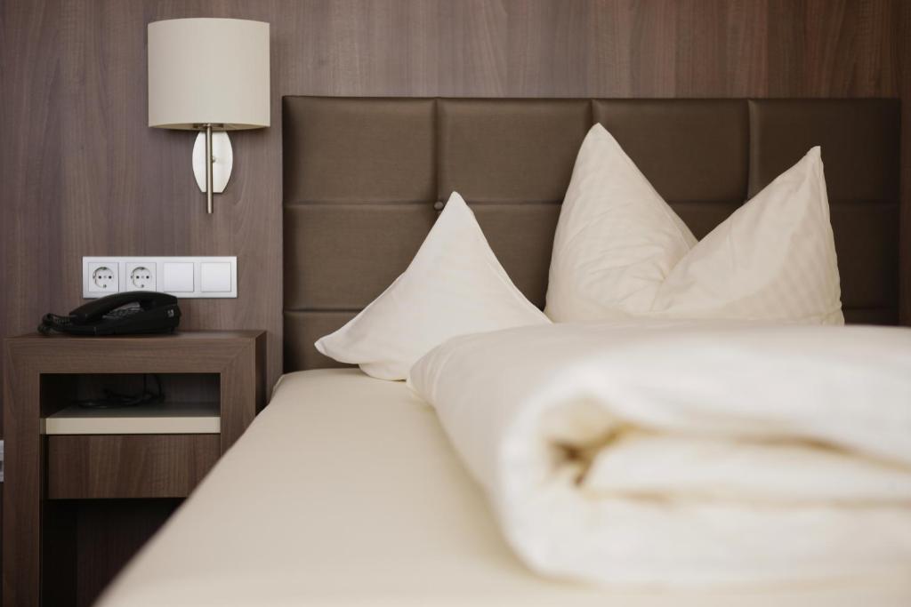 Postel nebo postele na pokoji v ubytování allgäu resort