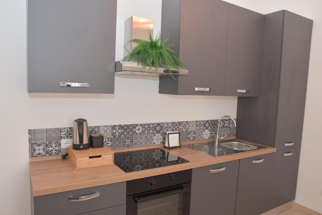 a kitchen with gray cabinets and a sink at Casa Ambra in Ancona