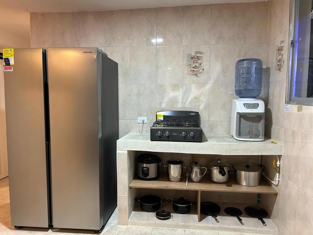 a kitchen with a stainless steel refrigerator and appliances at Casa Verbena in Cisneros