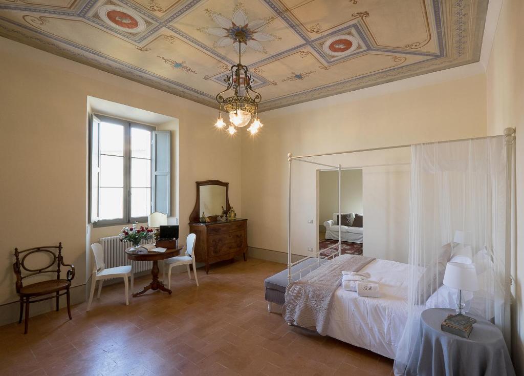 a living room filled with furniture and a large window at B&B Palazzo Mattei in Novafeltria