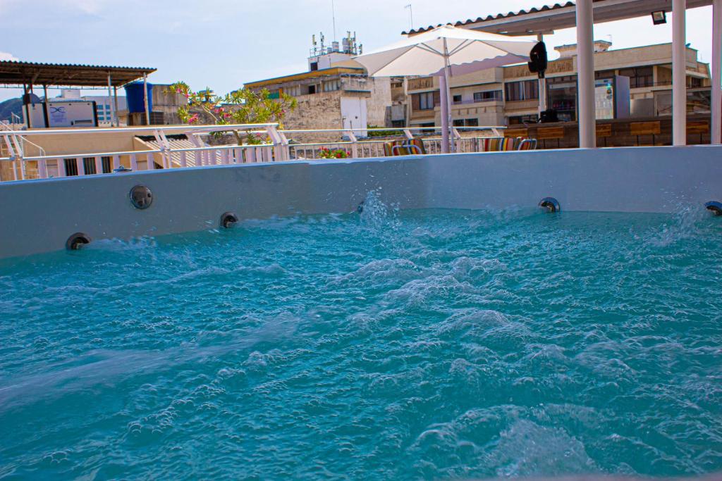 a pool of blue water in a swimming pool at Hotel El Olimpo in Santa Marta