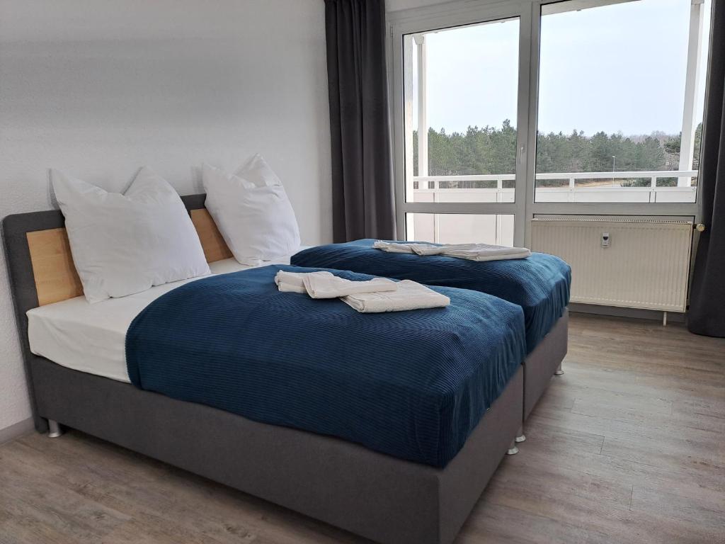 a bedroom with two beds with towels on them at BurgK59, 3 BR, 6 Beds, TV, Kitchen and Bath in Muldenstein