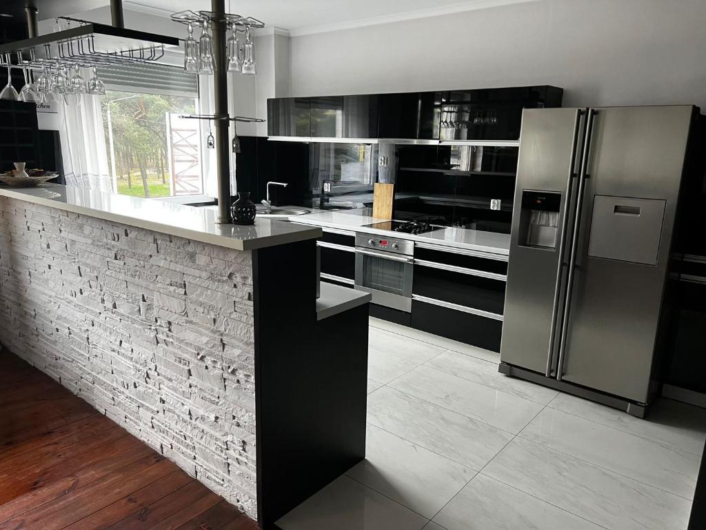 a kitchen with black and stainless steel appliances at Studio na Miarę in Jarocin