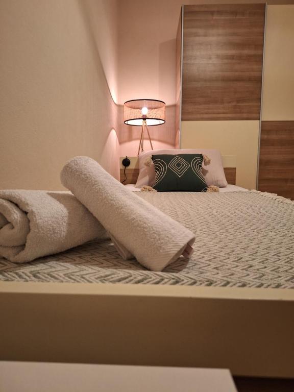 a bedroom with a bed with a towel on it at Studio Apartman Luna in Zadar