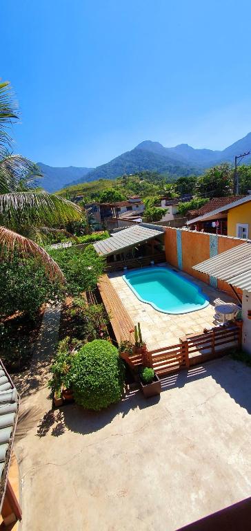 a view of a swimming pool in a house at Suítes no paraíso da Ilhabela in Ilhabela