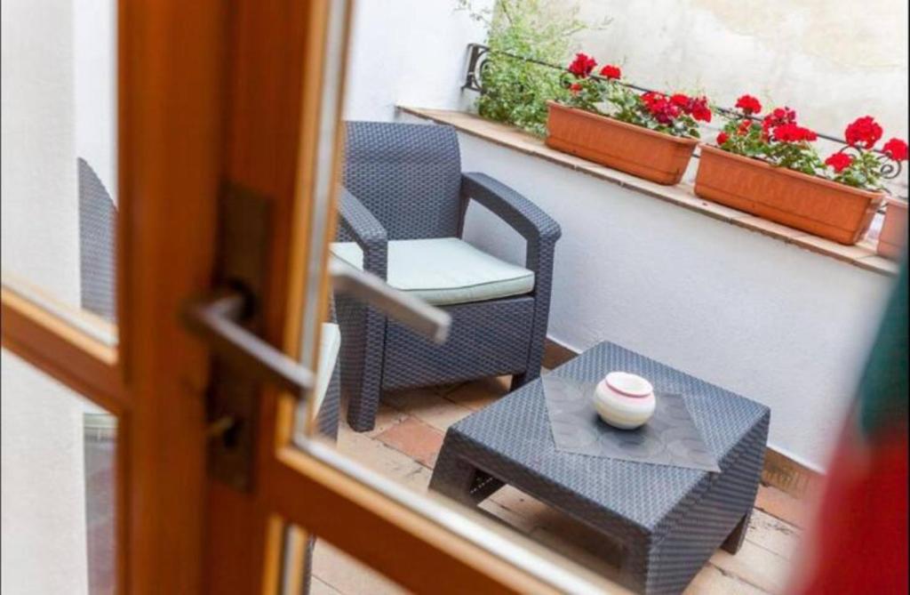 a view of a balcony with a chair and a table at ZMRZLINOVÝ DOMEČEK (Ice cream housei) in Mikulov