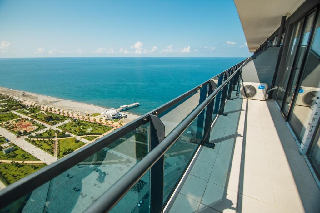 a view of the ocean from the balcony of a building at Apartments Beach Tower in Batumi