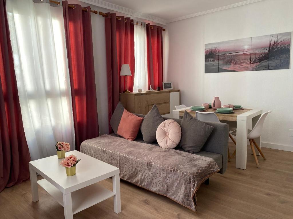 a living room with a couch and a table at Apartamento Plaza de las Flores in Murcia