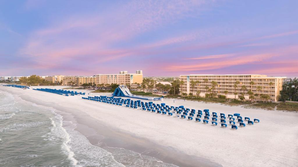 a line of blue chairs on the beach at TradeWinds Island Grand in St. Pete Beach