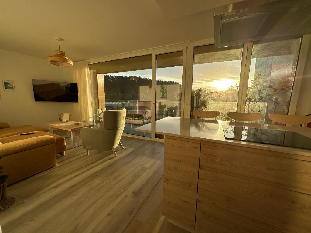 a kitchen and living room with a view of a living room at Sunset Limón in Piedras Blancas