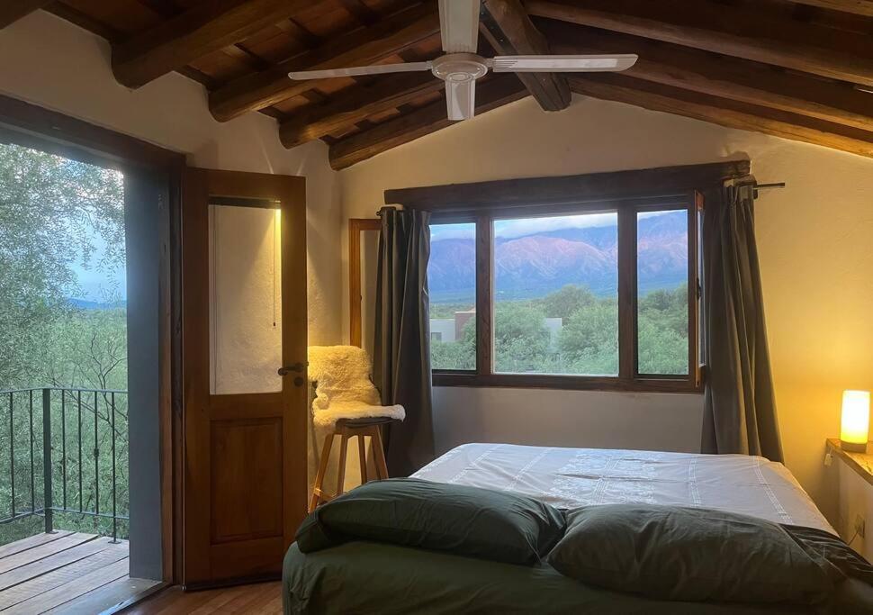 a bedroom with a bed and a large window at Casa en La Comarca in San Javier
