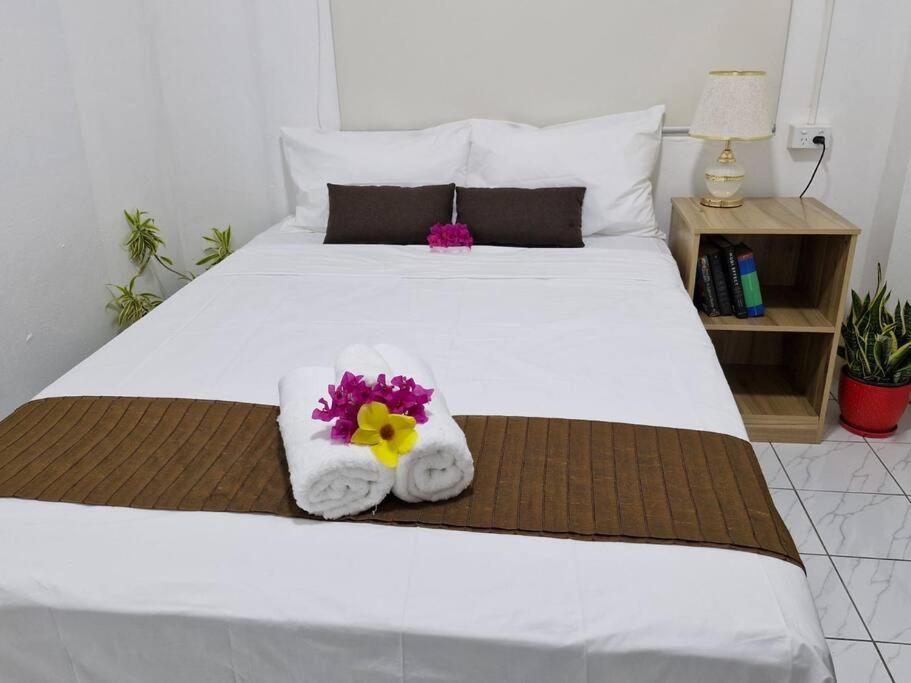 a bedroom with a bed with towels and flowers on it at JetPoint Holiday Home in Nadi