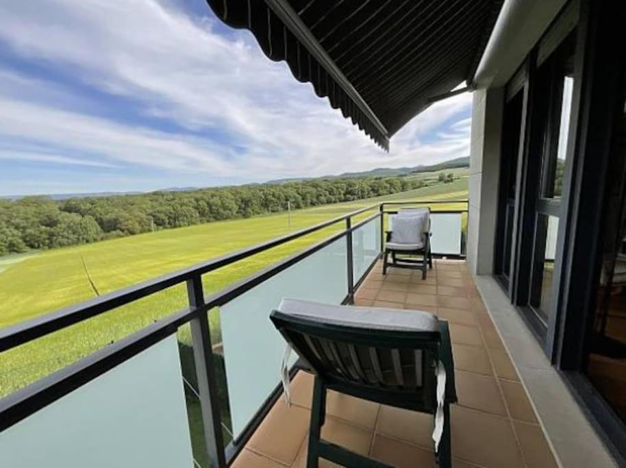 a balcony with a view of a body of water at Mirador Rioja alta golf in Cirueña