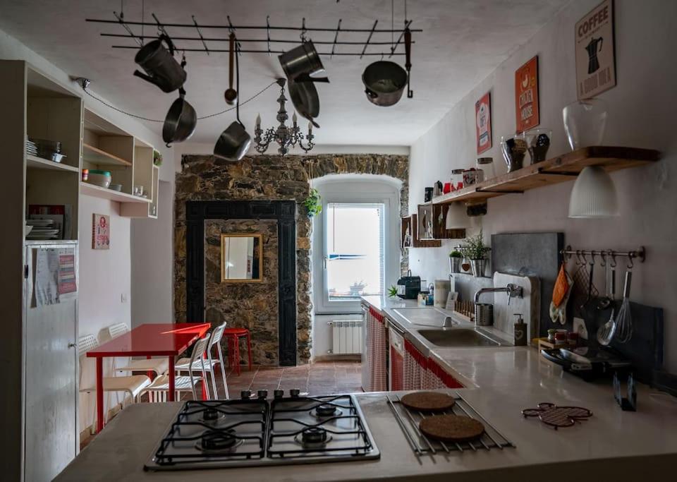 a kitchen with a stove and a counter top at Vezzhouse con Convenzione per Spa & Wellness in Vezzano Ligure
