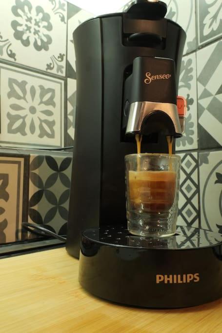 a coffee maker sitting on a table with a glass at Appartement centre ville de Pierrelatte&#39; in Pierrelatte
