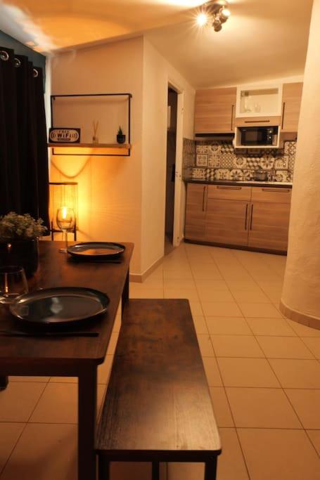 a kitchen with a sink and a table in a room at Appartement centre ville de Pierrelatte&#39; in Pierrelatte