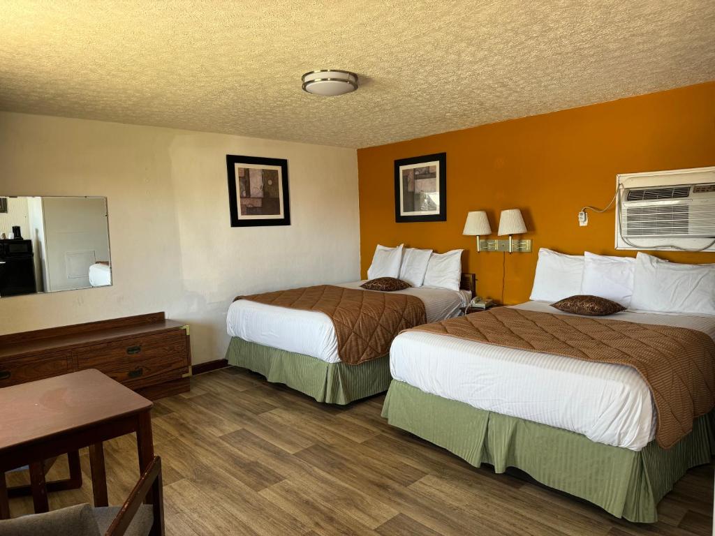 a hotel room with two beds and a table at Royal Inn in Albany