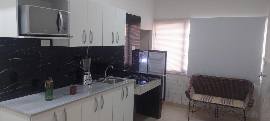a kitchen with a sink and a counter top at Apto cerca a Paseo Colon in Puerto La Cruz