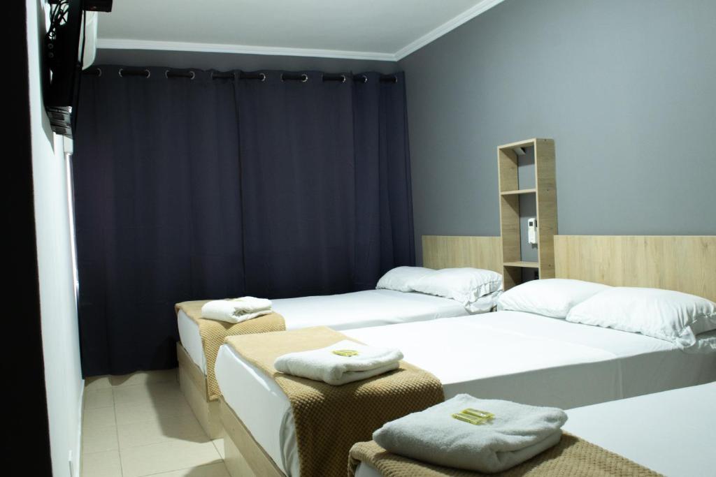 Postel nebo postele na pokoji v ubytování Hotel Ruiseñor Itagui