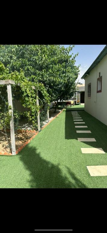 a yard with green grass and a building and trees at شاليه قلب الهدا 3-4 in Al Hada