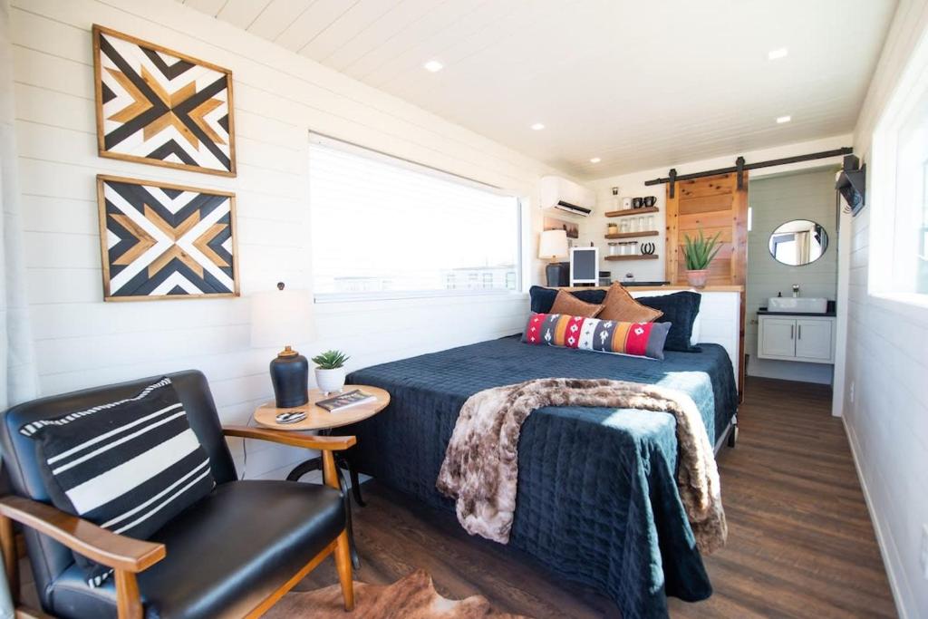 a bedroom with a bed and a chair at New The Buffalo-Shipping Container in Alpine in Alpine
