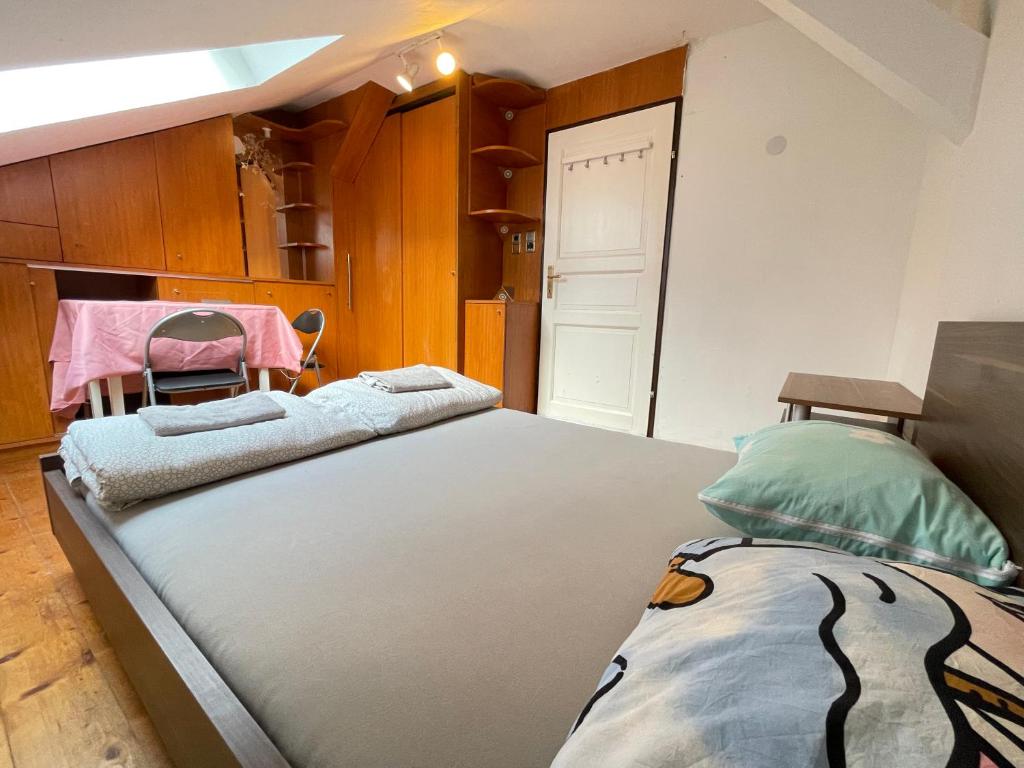 a bedroom with two beds and a closet at Schöpfwerk Hostel in Vienna