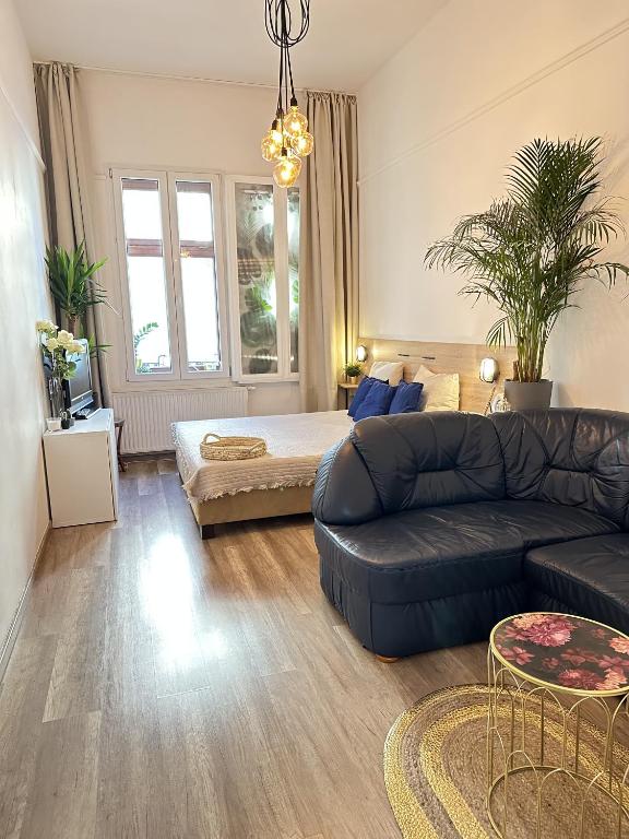 a living room with a couch and a table at The Nest Inn Budapest -Studio with AC in Budapest