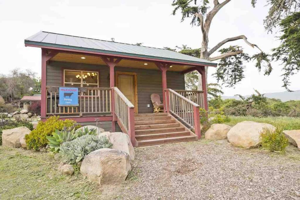 a small log cabin with a porch and stairs at Pacific Coast Highway Milkhouse in San Luis Obispo