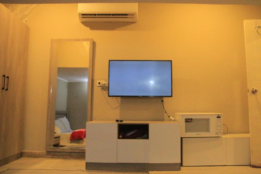 a living room with a flat screen tv on the wall at Elgouna in Hurghada