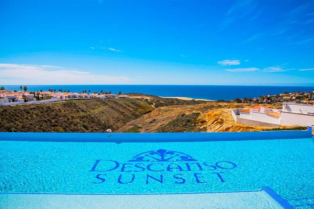 a view of the ocean from a resort sign at Voyage Vacation Club in Rosarito