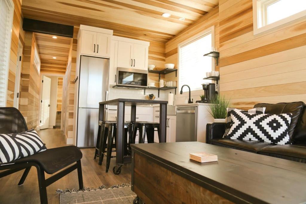 a living room and kitchen in a tiny house at Escalante Escapes Tumble Weed- Bunk Escape in Escalante