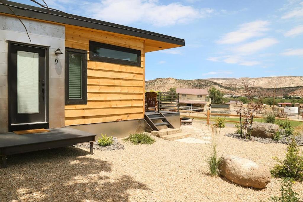 a tiny house in the desert with mountains in the background at Escalante Escapes Wild Rose- King Escape in Escalante